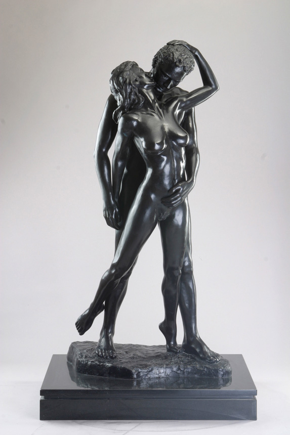 Entitled Les Amoureux or The Lovers, this is a photograph depicting a two, one-quarter life-size bronze sculptures of a standing male holding a female figure, created by sculptor Blake Ward