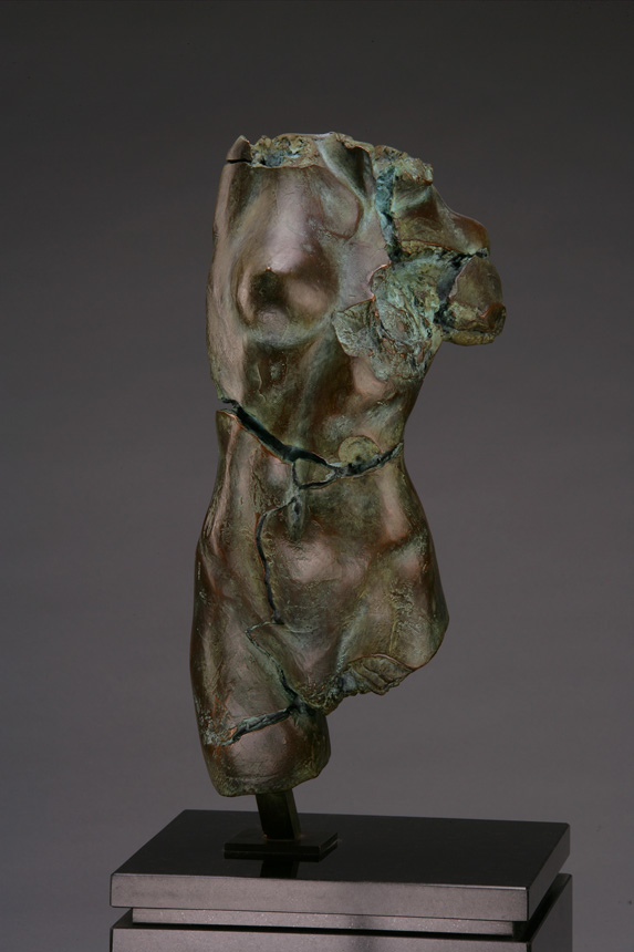 Entitled Apple P-40, this is a photo of a fragment of a one-quarter life size bronze sculpture. Depicted is the torso of a nude female figure missing her legs, arms, shoulders, neck and head. By sculptor Blake Ward.