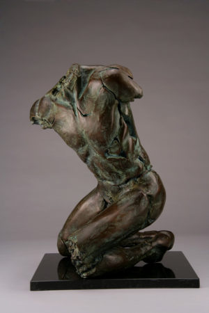 Entitled Butterfly PFM1, this is a photo of a fragment of a one-quarter life size bronze sculpture. Depicted is kneeling nude male figure missing his feet, arms, neck and head. By sculptor Blake Ward.