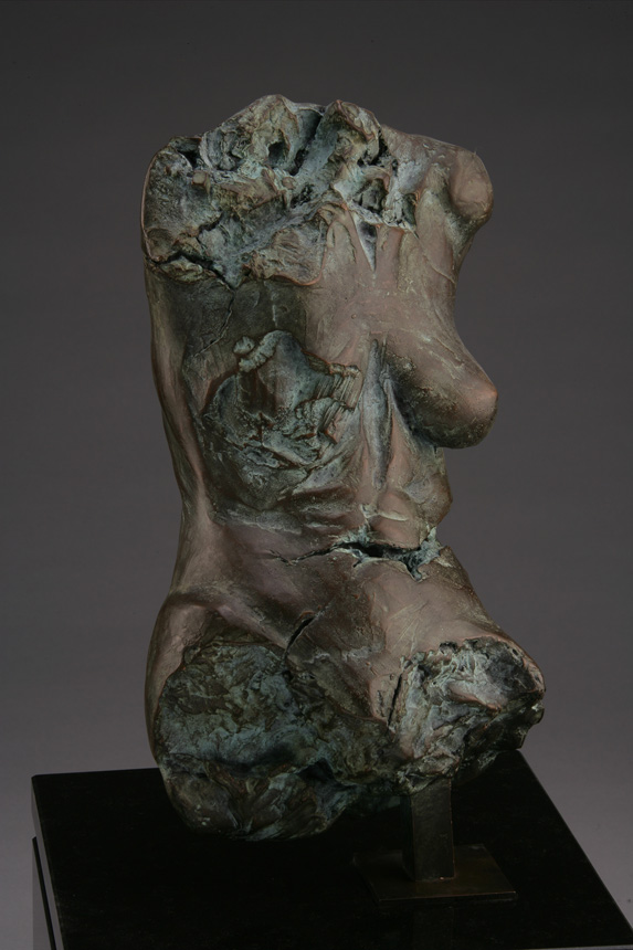 Entitled Claymore M18A, this is a photo of a fragment of a one-quarter life size bronze sculpture. Depicted is the torso of a nude female figure missing her legs, arms, shoulders, neck and head. By sculptor Blake Ward.