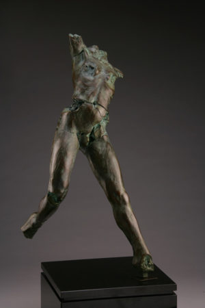 Entitled MON-50, this is a photo of a fragment of a one-quarter life size bronze sculpture. Depicted is standing nude female figure missing both her feet, both arms and head. By sculptor Blake Ward.