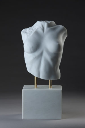 Entitled Lora From Another Land, this is a photograph depicting a one-quarter life-size sculpture of a partial female torso in marble, created by sculptor Blake Ward