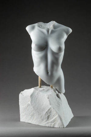 Entitled Adonael, this is a photograph depicting a one-quarter life-size sculpture of a partial female torso in marble, created by sculptor Blake Ward