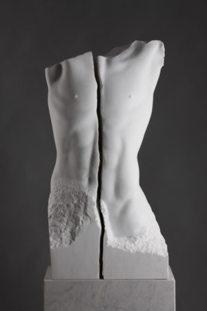 Entitled Faith, this is a photograph depicting a life-size marble sculpture of a male torso with a crack running lengthwise through the middle, created by sculptor Blake Ward