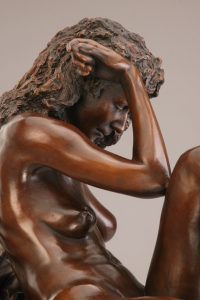 Entitled La Notte, this is a photograph depicting a one-quarter life-size bronze sculpture of a sitting female figure, created by sculptor Blake Ward