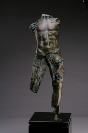 Entitled POMZ 2M, this is a photo of a fragment of a one-quarter life size bronze sculpture. Depicted is standing nude male figure missing his legs above the knee, both arms and head. By sculptor Blake Ward.
